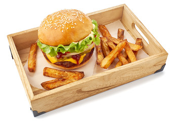 Wooden tray with hamburger and french fries on white