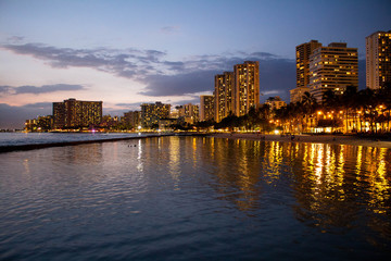 Fototapeta na wymiar Waikiki skyline at night with water reflection