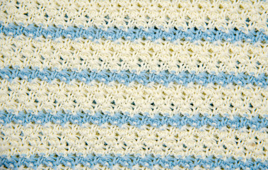 Blue and white striped knitted cotton backdrop. You can use it as a background for inserting text or advertising. Design.