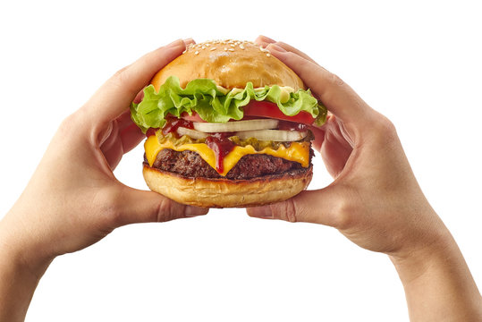 Hands holding hamburger on white
