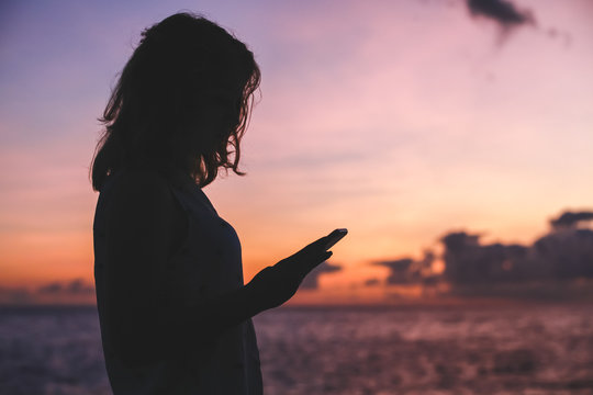 Silhouette photo of a girl with smartphone