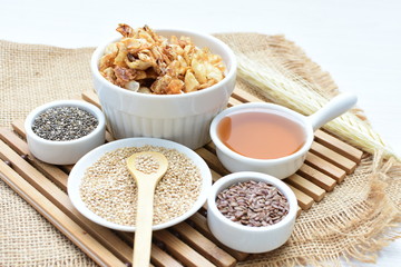 Granola mix accompanied by seeds and honey
