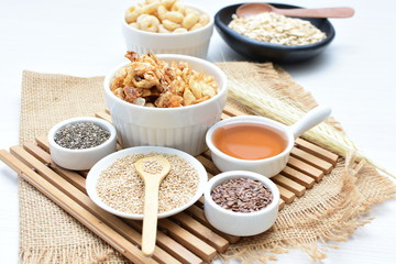 Granola mix accompanied by seeds and honey