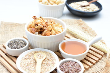 Granola mix accompanied by seeds and honey