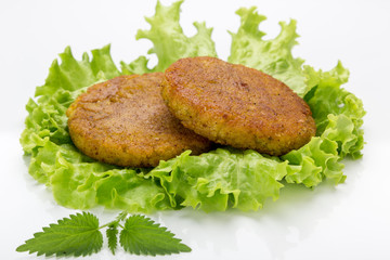 Cooked vegetarian cutlets on lettuce leaves. Fried breaded cutlet isolated on white background. freshly grilled burger vegetarian cutlets. Tasty crispy fried fresh cutlets. Juicy delicious cutlets