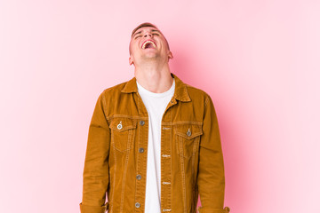 Young caucasian man isolated relaxed and happy laughing, neck stretched showing teeth.