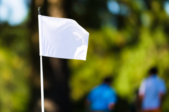 White Golf Flag Against a Green Background