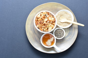 Granola mix accompanied by seeds and honey