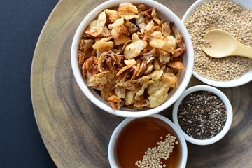 Granola mix accompanied by seeds and honey