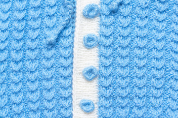 Blue knitted clothes texture background.