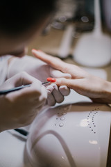 woman applying nail polish on her fingers