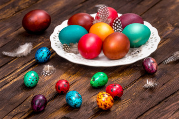 Fototapeta na wymiar Happy Easter. Painted eggs of different colors on a wooden table