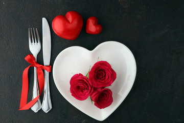 Obraz na płótnie Canvas Red rose on white dish. Meal on Valentines Day for the woman you love
