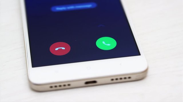 4K - Man answers a call on a smartphone