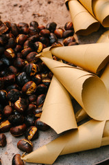 chestnuts ares old in the street of rome in winter time, christmas holidays, street food image.