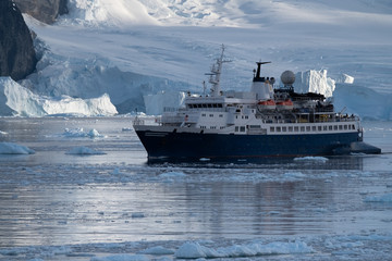 Cruise ship navigating through the stunning icy landscapes, Cuverville Island, Antarctic Peninsula, Antarctica
