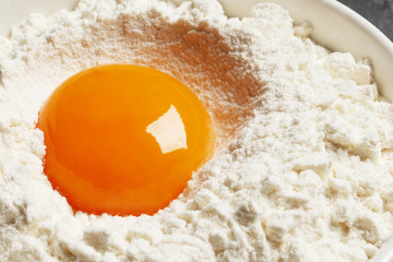 Yolk in flour closeup. Top