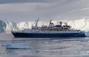 Cruise ship navigating through the stunning icy landscapes, Cuverville Island, Antarctic Peninsula, Antarctica