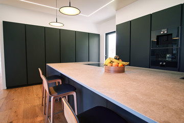 Modern kitchen with counter and chairs