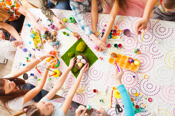 Top view kids hands with Easter crafts