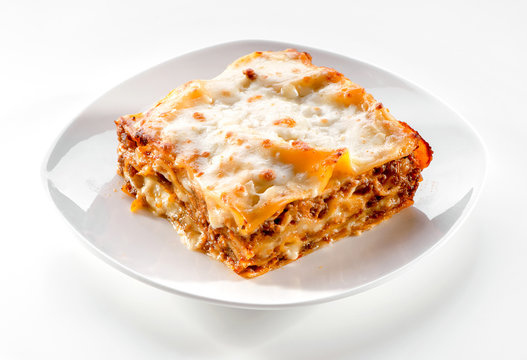 lasagna piece plate with minced meat and melted cheese close-up on white background