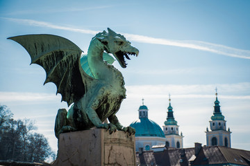 Dragon Bridge with Ljubljanska stolnica cathedral in the background, Ljubljana, Slovenia - obrazy, fototapety, plakaty