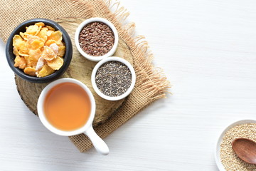 Obraz na płótnie Canvas Cereal flakes without sugar, accompanied by seeds, jam and honey