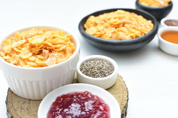 Cereal flakes without sugar, accompanied by seeds, jam and honey
