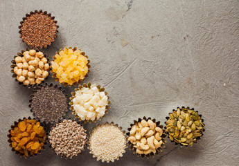 Obraz na płótnie Canvas Variety of nuts and dried fruits as a border, top view