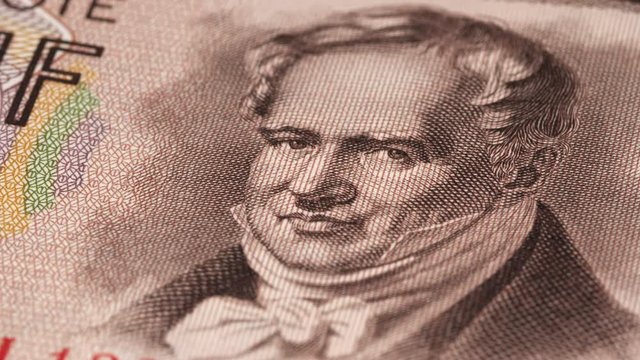 Alexander von Humboldt portrait on East German 5 mark (1964) banknote rotating. Famous German  geographer, naturalist and explorer, geography scientist. Low angle, macro. 4K, 422 10 bit
