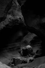 black and white photo of stone formation in a canyon 