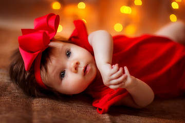 Fototapeta na wymiar little girl baby smiling with Christmas lights