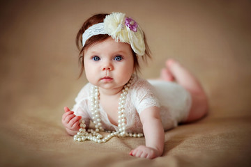 little girl baby in beads and jewelry