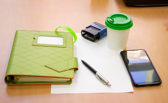 close-up Coffee on a wooden table showing break or breakfast in office.