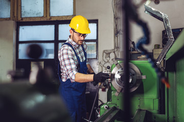 Fototapeta na wymiar Milling machine operator working in factory workshop.