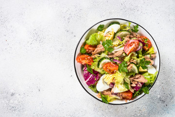 Tuna salad with green leaves, eggs and vegetables.