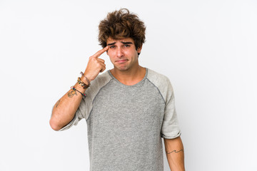 Young caucasian man against a white background isolated showing a disappointment gesture with...