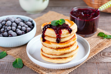 Stack of pancakes topped with berry jam