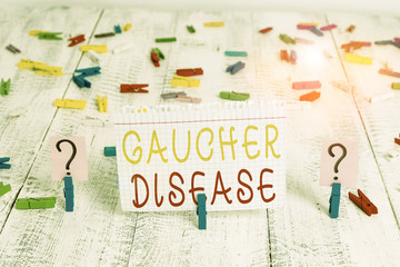 Word writing text Gaucher Disease. Business photo showcasing autosomal recessive inherited disorder of metabolism Scribbled and crumbling sheet with paper clips placed on the wooden table