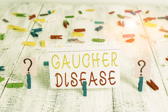 Word writing text Gaucher Disease. Business photo showcasing autosomal recessive inherited disorder of metabolism Scribbled and crumbling sheet with paper clips placed on the wooden table