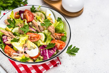 Tuna salad with green leaves, eggs and vegetables.