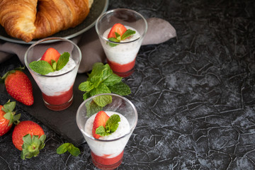 Natural yogurt with chia seeds and strawberries on a gray background. Breakfast chia seeds pudding with coconut milk and strawberries