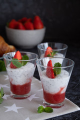 Natural yogurt with chia seeds and strawberries on a gray background. Breakfast chia seeds pudding with coconut milk and strawberries