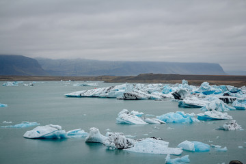 Icebergs in Jokulsarlon lagoon beneath Breidamerkurjokull glacier Sudhurland, Iceland. Place for text or advertising