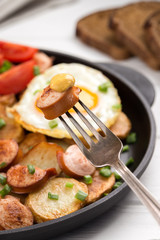 Fried sausage on a fork with mustard. Selective focus. Breakfast. Grilled Sausage on a fork. close-up image of sausage and fork