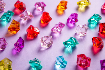 multi-colored crystals on a purple background. stones of different shapes