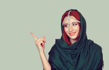 Advertising. Beautiful happy girl woman showing look here index finger gesture with hand. Positive...