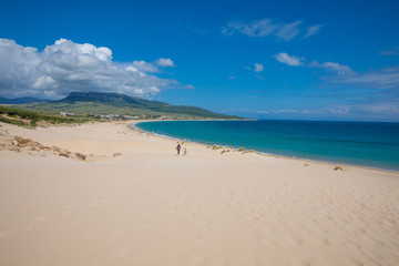 beautiful landscape of wild natural Beach Bolonia in Tarifa, Cadiz, Andalusia, Spain, with woman and little girl walking. Copy or text space
