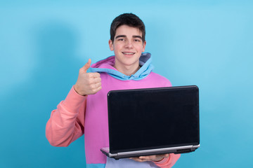 young teenage student with personal computer isolated on color background