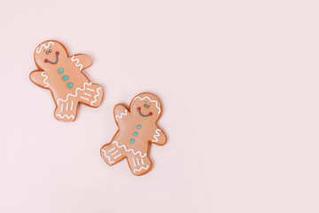 Couple of ginger cookies on pale beige background with copy space.